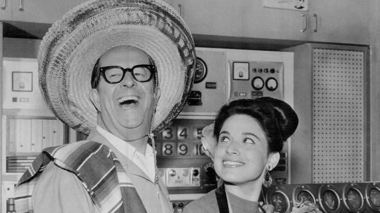 Phil Silvers sports a sombrero as Harry Grafton while celebrating Mexico Day with Mina Martinez as Mother in The New Phil Silvers Show