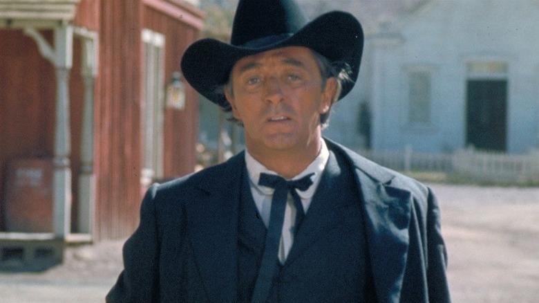 Preacher (Robert Mitchum) standing outside in "5 Card Stud"