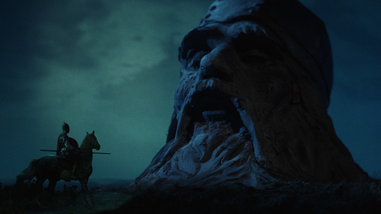 Valeri Kozinets as Ruslan, talking with a decapitated giant head in Ruslan and Ludmila