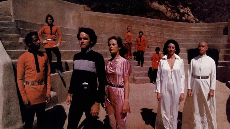 Logan 5 (Gregory Harrison) and Jessica 6 (Heather Menzies) walk through a stylized society's amphitheater in Logan's Run