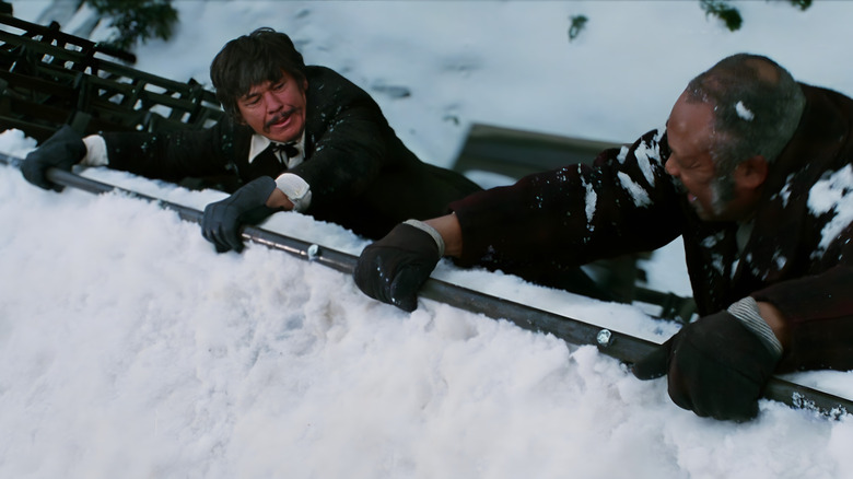 John Deakin and a soldier dangling from a train in 