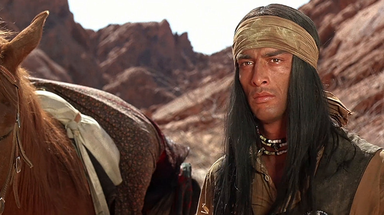 Ke-Ni-Tay standing next to his horse in "Ulzana's Raid."