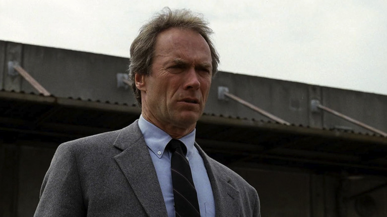 Clint Eastwood as Harry Callahan frowning while looking over a bridge in The Dead Pool