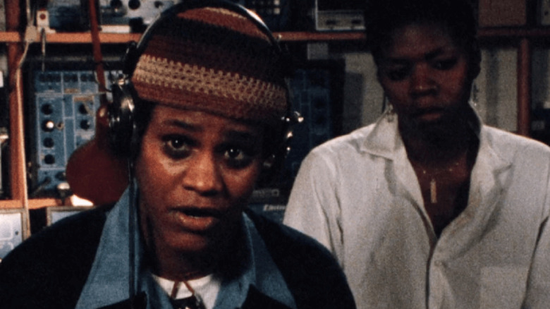 Honey and a friend in a recording booth in Born in Flames