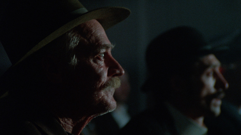Bill Miner (Richard Farnsworth) sitting in a theater in "The Grey Fox"