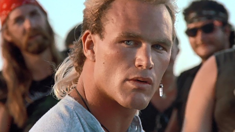 Joe Huff (Brian Bosworth) standing in front of a gang in "Stone Cold."