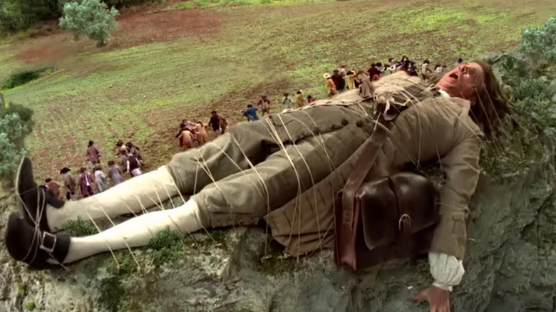 Lemuel Gulliver tied to the ground by Lillliputians in Gulliver's Travels