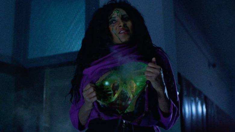 Miss Connors peeling open her human suit in Class of 1999