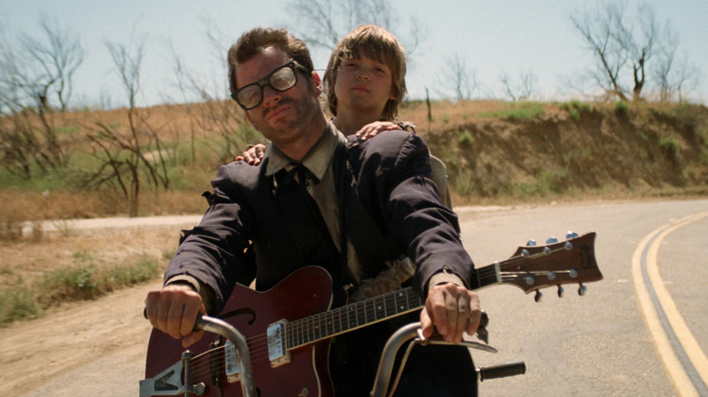 Buddy and the Kid on a bicycle in Six-String Samurai