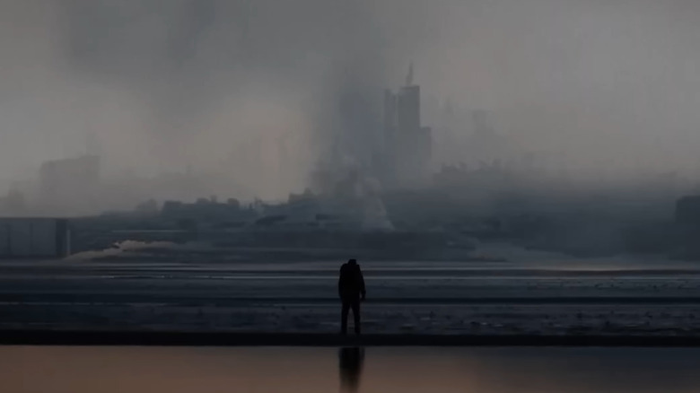Nicolas Cage as Paul looking at a smoldering city in Arcadian
