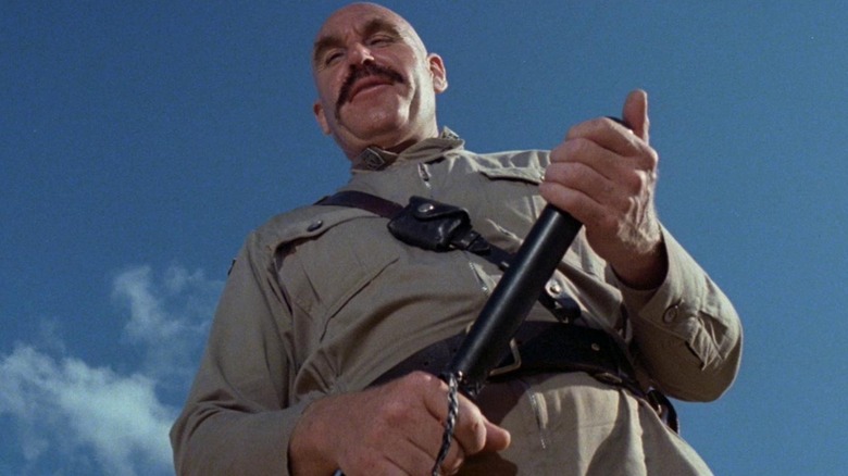 Ritter towering over someone in Turkey Shoot