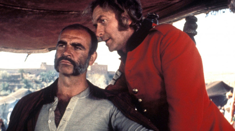 Daniel Dravot conspiring with Peachy Carnahan in The Man Who Would Be King