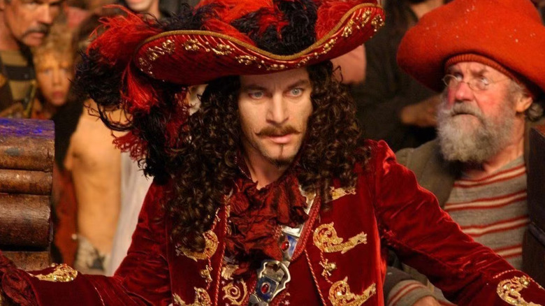 Captain Hook surrounded by pirates and Lost Boys in Peter Pan