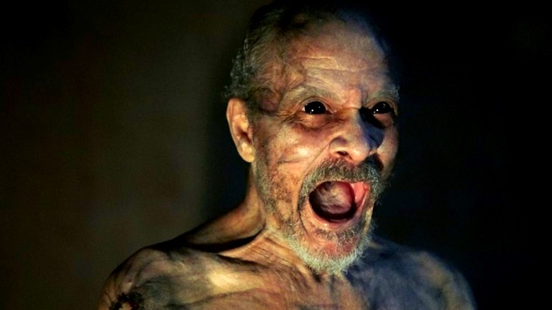 An old man with scary eye screaming in It Comes at Night