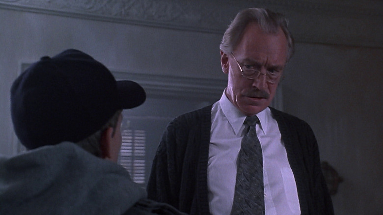 Leland Gaunt looking at a boy in a ballcap in Needful Things