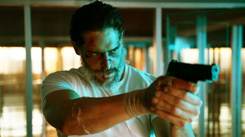 Joe Manganiello as Max Fist with a pistol up in Archenemy