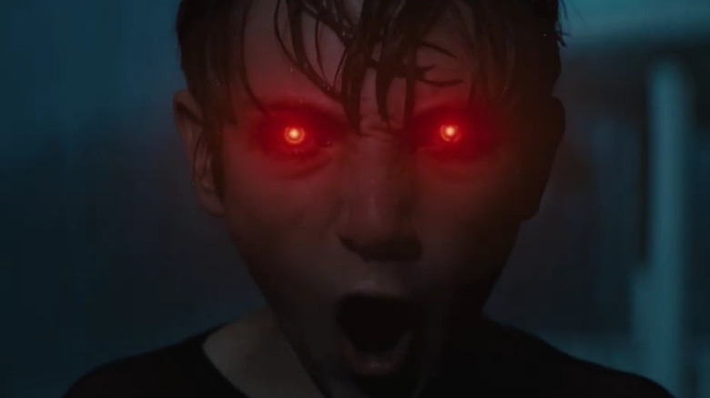 Jackson A. Dunn as Brandon with his eyes glowing red in Brightburn