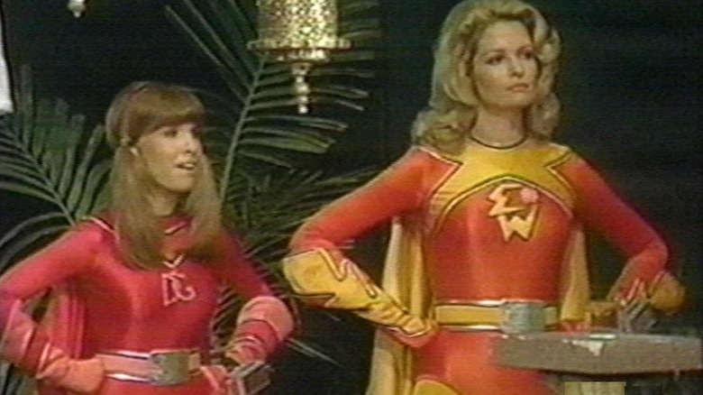 Dyna Girl and Electra Woman arms akimbo in Electra Woman and Dyna Girl