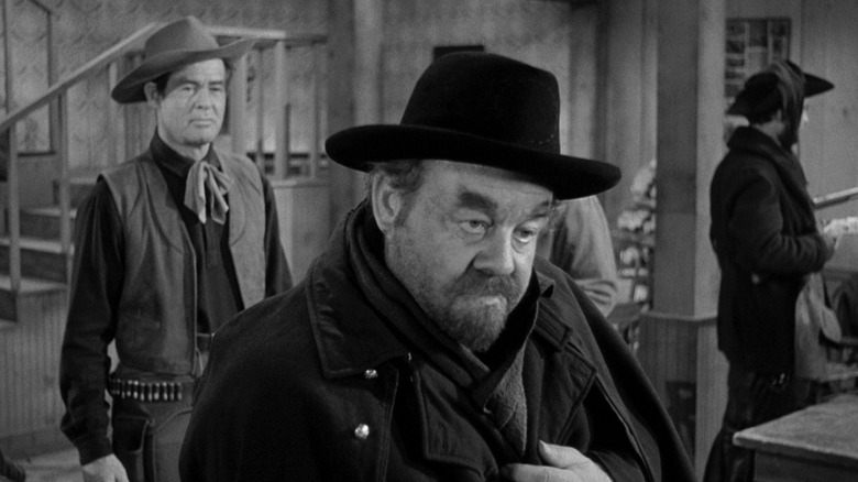 Robert Ryan as Blaise Starrett keeps a close eye on Burl Ives as Jack Bruhn in Day of the Outlaw