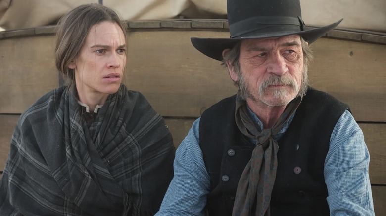 Tommy Lee Jones as George Briggs rides a wagon with Hilary Swank Mary Bee Cuddy in The Homesman