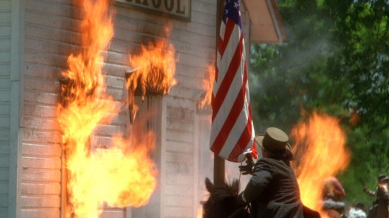 Bushwhackers set fire to a school during the Lawrence Massacre in Ride with the Devil