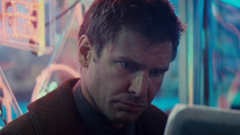 Rick Deckard looking a little overwhelmed while reading in Blade Runner