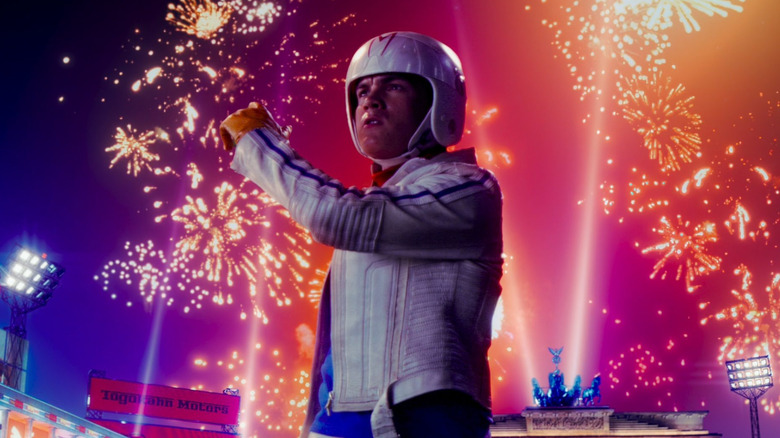 Speed posing with fireworks behind him in Speed Racer