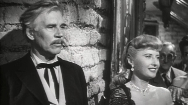 Walter Huston's T. C. Jeffords stands beside Barbara Stanwyck's Vance Jeffords in The Furies