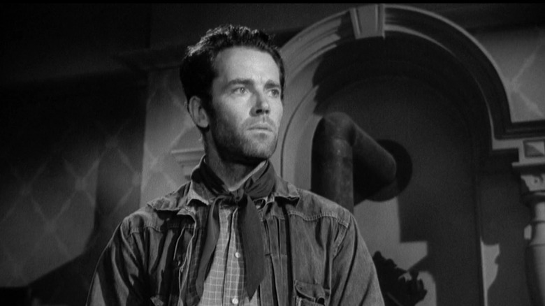 Henry Fonda's Gil Carter stands in a room holding his hat in The Ox-Bow Incident