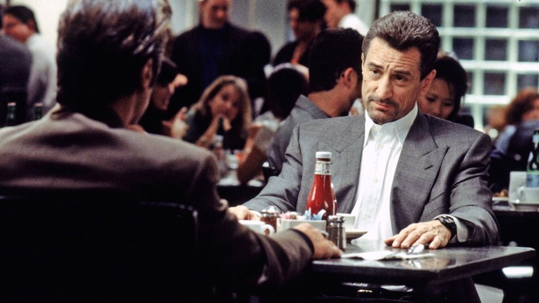 Neil sitting across from Vincent at the diner table in Heat