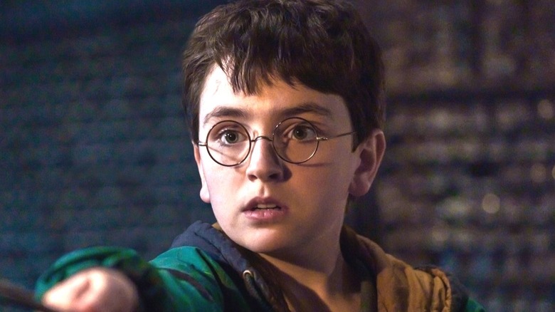 Harry frightened pointing his wand in the Harry Potter trailer