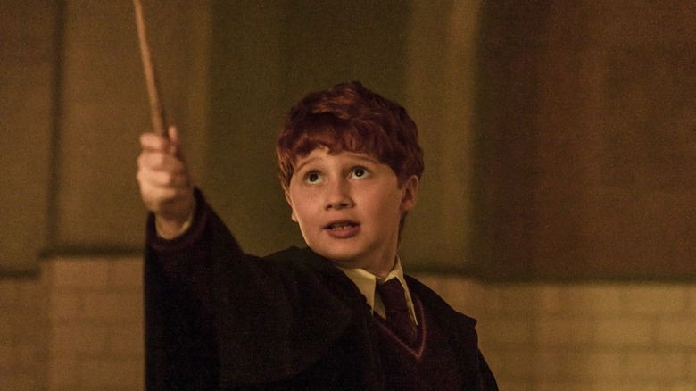 Ron holding his wand aloft in Harry Potter and the Philosopher's Stone