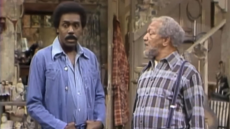 Fred Sanford looking at Lamont in a purple jacket on Sanford and Son