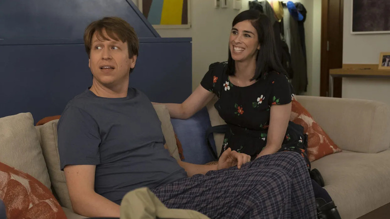 Pete and Sarah on a couch on Crashing