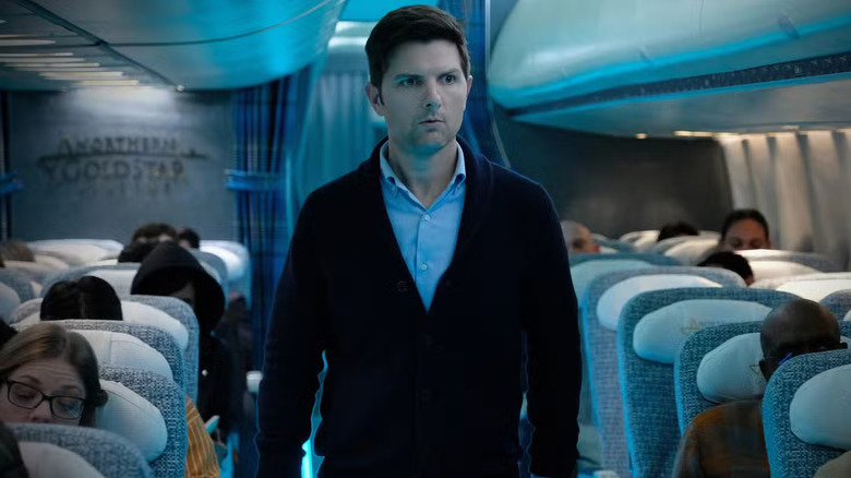 Justin Sanderson in the aisle of a plane on The Twilight Zone