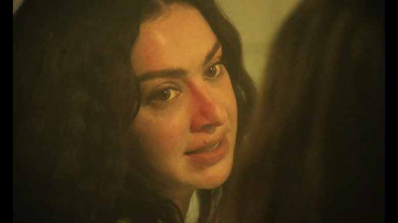 Charli talking to someone in The Moment