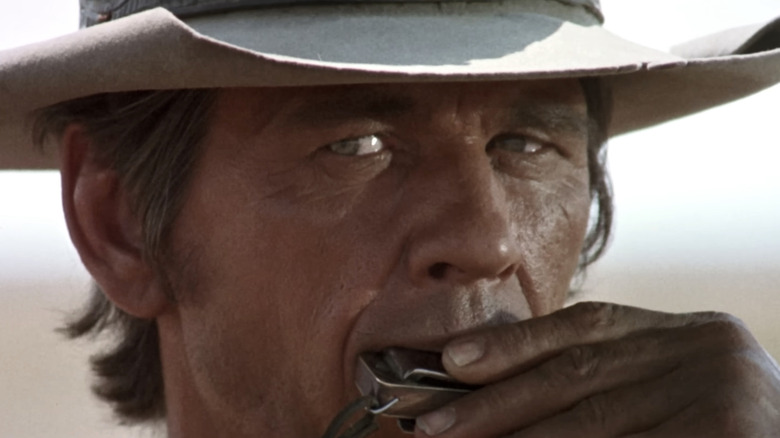 Charles Bronson's Harmonica plays his Harmonica in closeup in Once Upon a Time in the West