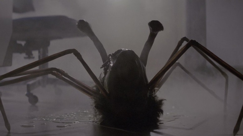 A severed human head with bug legs in The Thing