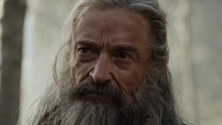 Hugh Jackman as Robin Hood smiling thoughtfully in The Death of Robin Hood