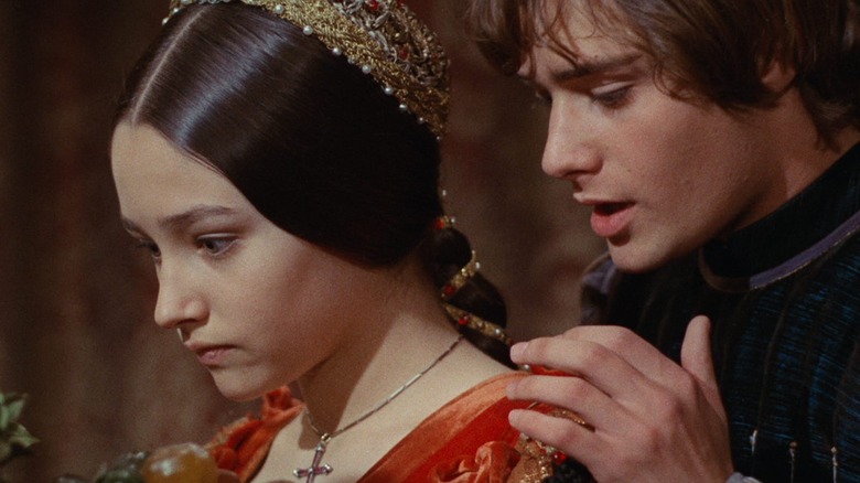 Juliet being held from behind by Romeo in Romeo and Juliet