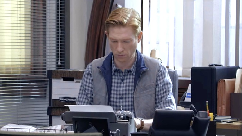 Ned sitting at his desk on "The Paper"