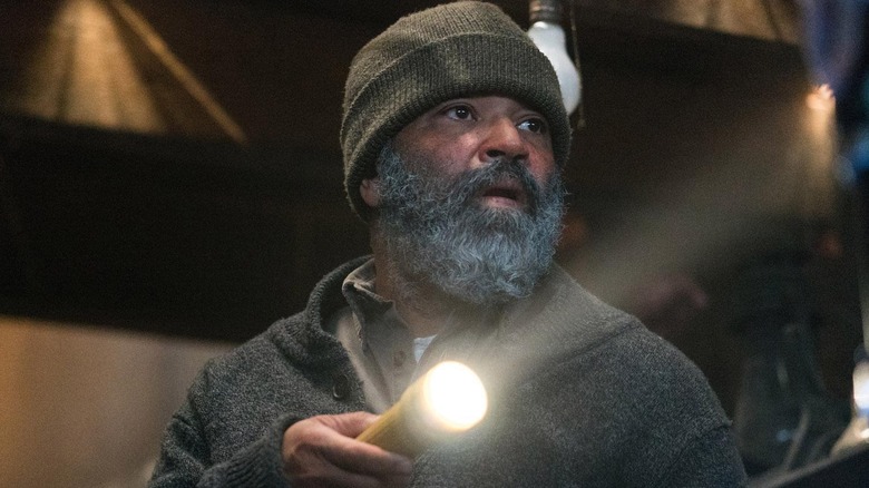 Jeffrey Wright as Russell holding a flashlight in Hold the Dark