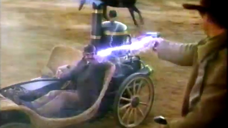 Nicodemus Legend (really Ernest Pratt) firing a bolt of electricity at a gunslinger in Legend