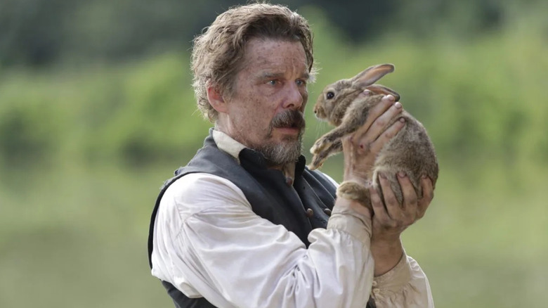 Ethan Hawke as John Brown holding a bunny in The Good Lord Bird