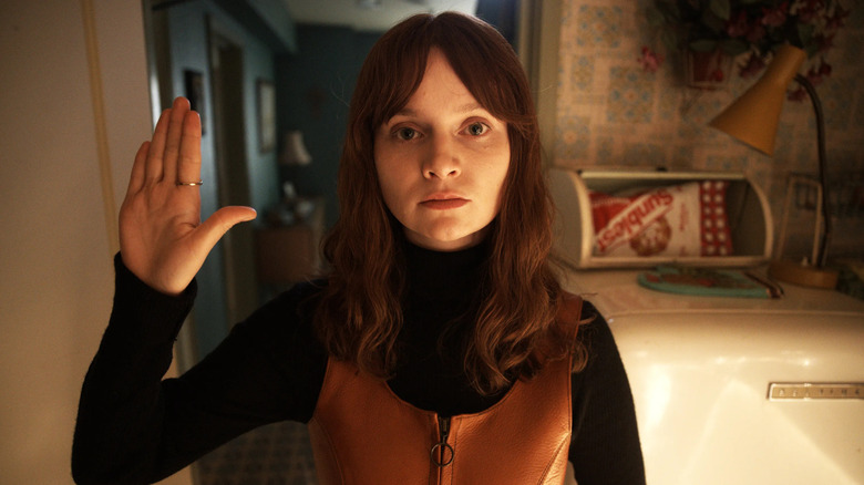 Dolours raising her right hand and looking scared on Say Nothing