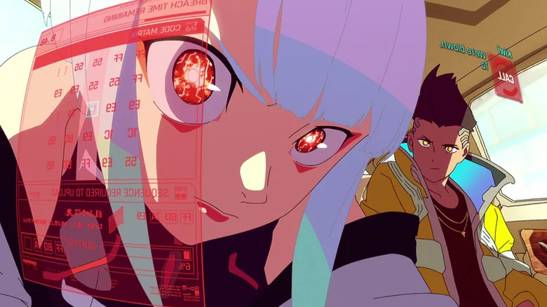 Lucy looks at a projection of a computer screen while David looks at her concerned in Cyberpunk: Edgerunners
