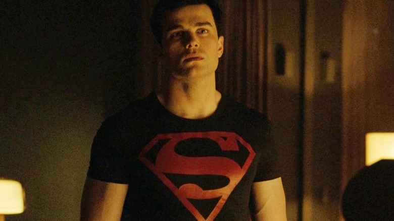 Conner stands in a room with a Superman t-shirt in Titans