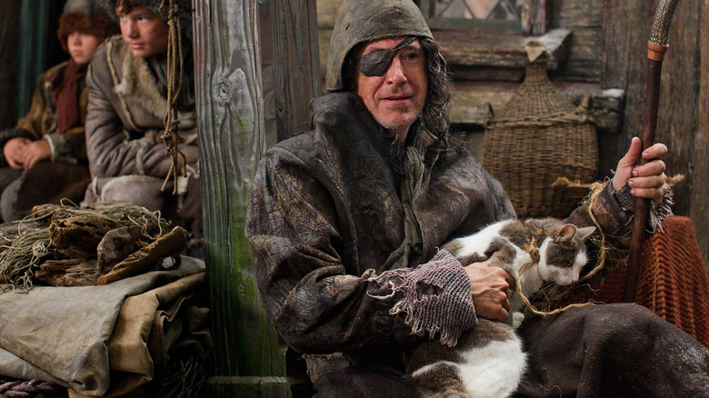 Stephen Colbert as a Laketown spy wearing an eyepatch and holding a cat in The Hobbit: The Desolation of Smaug