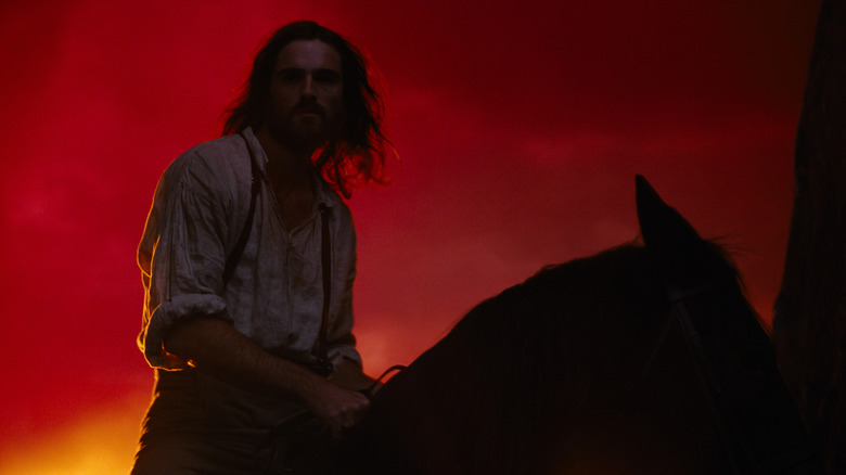 Jacob Elordi as Heathcliff riding a horse against the sunset in Wuthering Heights (2026)
