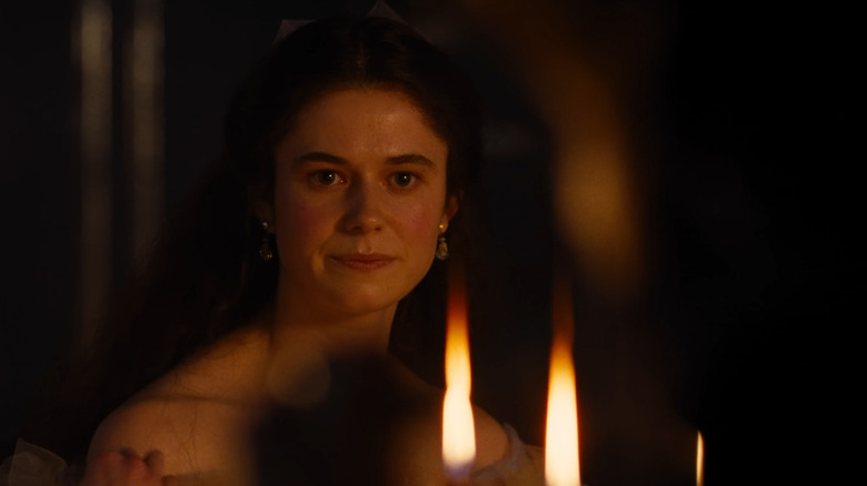 Alison Oliver as Isabella looking at Heathcliff across the table in Wuthering Heights (2026)